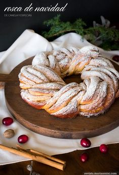 a wooden plate topped with powdered sugar covered bread