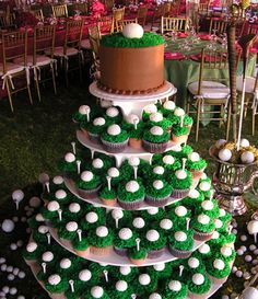 a cake and cupcakes are stacked on top of each other