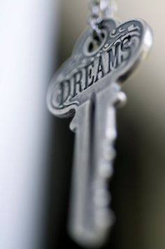 a key with the word dreams hanging from it