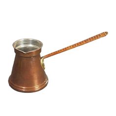 an old fashioned metal cup with a wooden spoon in it's holder on a white background