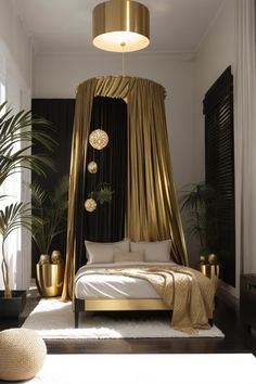 a gold canopy bed in a bedroom with black drapes on the walls and floor