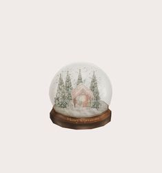 a snow globe with a house and trees inside