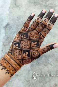 a woman's hand with henna tattoos on it