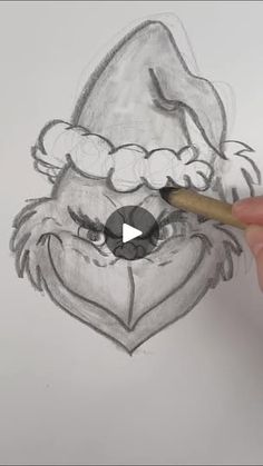 someone is drawing a santa claus face with a pencil