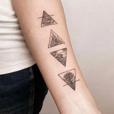 a woman's arm with three triangle tattoos on the left side of her arm