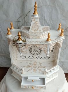 an ornate white and gold jewelry box