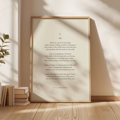 an image of a book shelf with books and a framed quote on it in front of a white wall