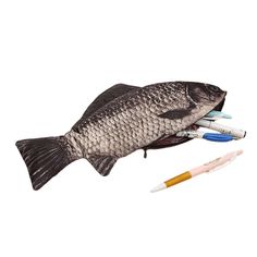 a fish with pens and markers in its mouth