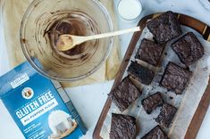 chocolate brownies on a cutting board next to a package of gluten free ice cream