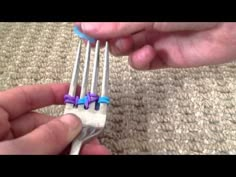 a person holding two forks with purple and blue handles