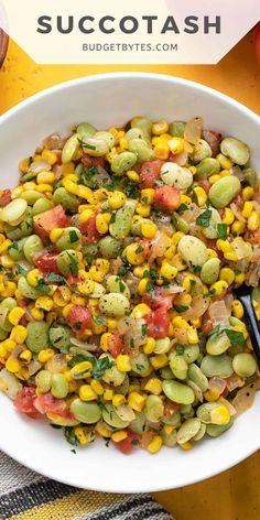 a white bowl filled with corn and vegetables