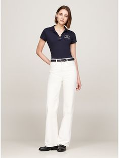 Tommy Hilfiger women's polo. For a classic, casual look, reach for this comfortable stretch-cotton pique polo. Cut in a figure-flattering slim fit with a button placket, and summer-friendly short sleeves.  Material: 96% Cotton (rgc), 4% Elastane. Fitted Polo Shirt With Button Closure For Spring, Fitted Polo Shirt For Workwear In Spring, Fitted Polo Shirt For Spring Workwear, Stretch Polo Shirt For Work, Fitted Short Sleeve Tommy Hilfiger Polo Shirt, Fitted Tommy Hilfiger Polo Shirt With Short Sleeves, Casual Fitted Tommy Hilfiger Polo Shirt, Fitted Tommy Hilfiger Casual Polo Shirt, Fitted Tommy Hilfiger Polo Collar Top