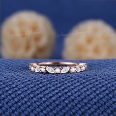 a close up of a wedding ring on a blue cloth