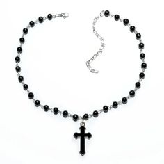 "Indulge in edgy elegance with our Silver Gothic Beaded Cross Charm Necklace. Made with stunning black beads and a beautifully intricate cross charm, this necklace is the perfect accessory for anyone looking to make a statement. Showcase your unique style and add a touch of sophistication to any outfit with this one-of-a-kind piece! Good to Know: Adjustable fastening  Silver Plated  Nickel Free  Charm Size 20mm x 10mm  Necklace Length 21\" - 24\" with Adjuster" Black Adjustable Crucifix Necklace, Adjustable Black Crucifix Necklace, Adjustable Cross Necklace With Black Beads, Adjustable Black Beads Cross Necklace, Gothic Beaded Cross Jewelry, Gothic Black Necklace With Black Beads, Gothic Black Cross Pendant Necklace, Gothic Black Metal Cross Necklace, Edgy Metal Cross Necklace