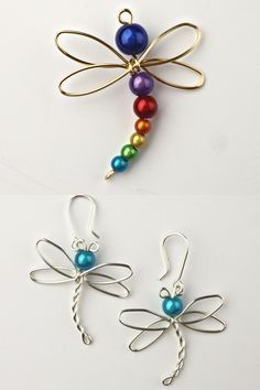 two dragon shaped earrings with multicolored beads hanging from hooks on a white surface