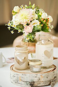 mason jars filled with flowers on top of a table