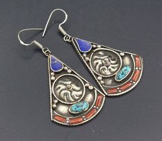 "I am Offering you this Nepalese Tibetan earrings. Beautiful hand crafted workmanship with inlay Coral & Turquoise Stones with lovely tear drop shape. If you have any questions about this piece, or would you like further information or photographs please do not hesitate to contact me. Thanks for taking the time to look at this piece. Please visit my store for other Beautiful and lovely similar items thank you. Please know what you are bidding on. The metal of Most Kuchi, Afghan and Turkoman Vintage Blue Earrings For Festival, Traditional Inlay Earrings As Gift, Traditional Inlay Earrings For Gift, Traditional Silver Earrings With Inlay, Traditional Blue Pendant Earrings, Tibetan Earrings, Stones Earrings, Afghan Jewelry, Tibetan Turquoise