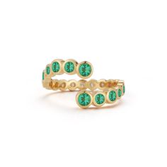 Vibrant green emeralds graduate around the finger in delicate gold bezel settings. Approximately .83 tcw. Size 6 ships within 5 business days. Green Rings With Bezel Setting For May Birthstone, Green Bezel Set Rings For May Birthstone, Green Emerald Stackable Ring, Timeless Green Open Ring Emerald, Green Emerald Ring With Tension Setting, Stackable Green Emerald Ring, Emerald Ring With Bezel Setting And Open Design, Everyday Emerald Open Ring, Green Emerald Ring With Bezel Setting