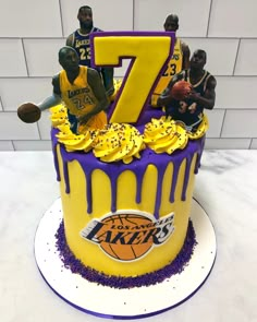 a birthday cake with the number seven on it and basketball players in yellow and purple icing