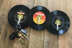 three black records with keys attached to them