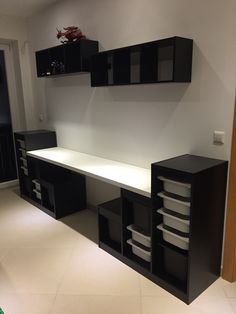 an empty room with black cabinets and white counter tops