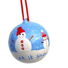 a snowman ornament hanging from a red string on a white background with words let it snow