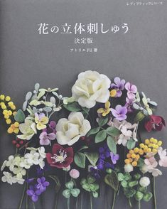 a book with flowers on the cover in english and japanese characters written in human language