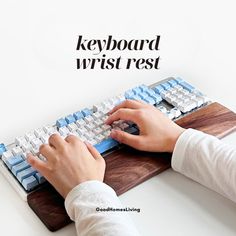 a person typing on a keyboard with the words keyboard wrist rest above it and below it