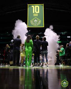 a group of people standing next to each other on a basketball court