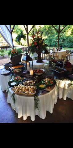 a table filled with lots of food under a tent