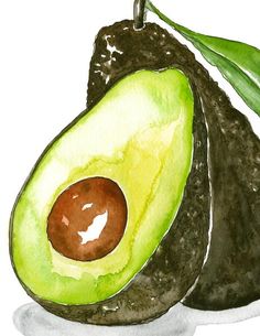 an avocado on a plate with a green leaf