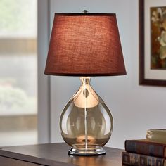 a lamp that is sitting on top of a table next to a bookshelf