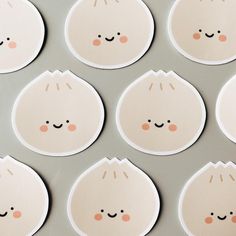 several stickers with faces on them are arranged in rows, one has eyes and the other has ears