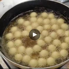 a pan filled with balls of food on top of a stove