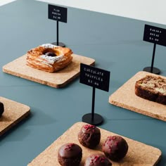 several different types of pastries displayed on small trays