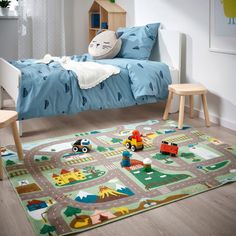 a child's bedroom with toys on the floor and in front of the bed