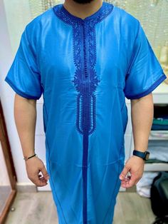 Discover traditional elegance with our Kamiss Men's Caftan in blue. Crafted with care, this kaftan offers timeless style and modern sophistication. Delicately embroidered along the neckline and cuffs, this kaftan brings a touch of refinement to your look. Comfortable and versatile, it is perfect for all occasions. Order today and add a touch of class to your wardrobe with the Kamiss Men's Caftan in blue. Blue Agbada With Traditional Patterns For Ceremonies, Blue Traditional Agbada For Ceremonies, Blue Agbada For Traditional Ceremonies, Traditional Blue Agbada For Ceremonies, Traditional Blue Agbada With Traditional Patterns, Blue Kurta With Traditional Patterns For Ceremonies, Traditional Short Sleeve Kaftan, Traditional Short Sleeve Kaftan For Ceremonies, Embroidered Blue Kaftan For Traditional Ceremonies