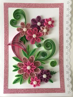 a card with paper flowers and swirls in pink, purple, green and white