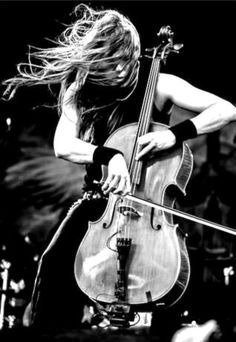 a woman with long hair playing an instrument