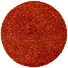 an orange round rug on a white background