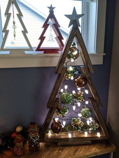 a wooden christmas tree with lights on it