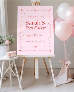 a welcome sign with pink balloons in the background and a baby shower sign on easel next to it