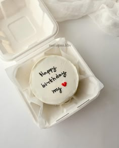 a happy birthday cake in a plastic container