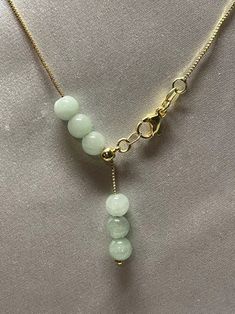 Natural Jade Bead Necklace . Simple design and nice looking. Material : Jade , Gold filled chain Jade Size: 6mmColor: Light Green Jade , Yellow gold filled & Silver color chain Chain Length: adjustable from 14 inches up to 16.5 inches. Packing : Nice silk Bag Elegant Jade Necklace With Adjustable Chain, Gold Jade Round Beads Jewelry, Gold Jade Beaded Jewelry, Gold Jade Round Beaded Jewelry, Gold Jade Necklaces With Polished Beads, Adjustable Beaded Necklaces With Round Beads And Chain, Adjustable Beaded Necklace With Round Beads And Chain, Adjustable Beaded Chain Necklace With Pendant, Adjustable Beaded Chain Pendant Necklace