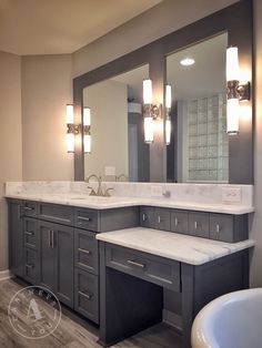 a large bathroom with two sinks and a bathtub in the middle of the room