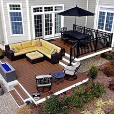 a deck with furniture and an umbrella over it