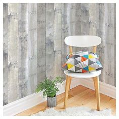 a white chair sitting in front of a wall with wooden planks on it's sides