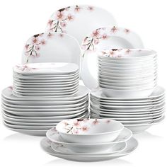 a stack of white plates with pink flowers on them