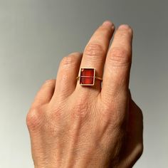 This vintage, octagonal carnelian tile with a vivid orange tone is uniquely Captured in 18k gold. Elegantly geometric, this ring has a classically modern feel with Hilary's signature Captured setting. 18k gold, carnelian. Made to order and will ship in 2-3 weeks. Formal Red Carnelian Signet Ring, Red Carnelian Signet Ring With Polished Finish, Red Rectangular Ring With Polished Finish, Red Rectangular Rings With Polished Finish, Modern Red Ruby Ring, Rectangular Red Rings With Polished Finish, Modern 14k Gold Red Rings, Red Carnelian Signet Ring For Anniversary, Modern Carnelian Jewelry For Formal Occasions