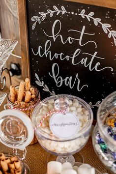 an assortment of desserts and snacks on a table with a sign that says hot chocolate bar